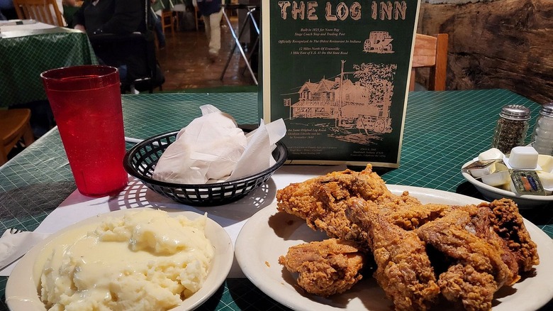 A table at The Log Inn with a serving of fried chicken and mashed potatoes