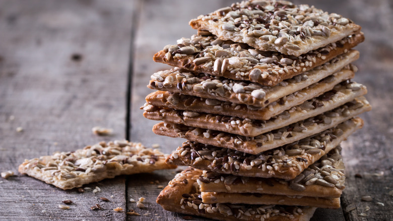 Seeded crackers on wooden background