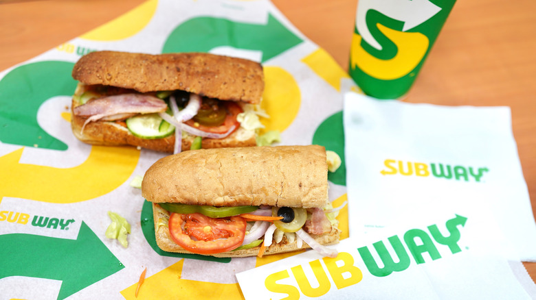 Two Subway sandwiches on paper