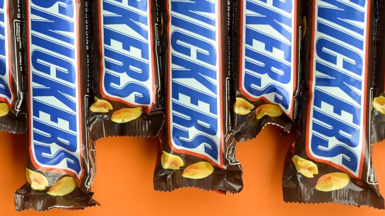 Snickers bars against orange background