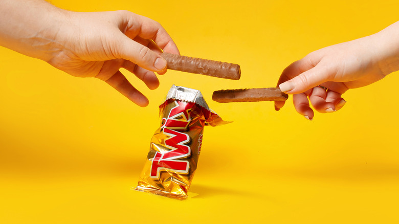 hands holding Twix bars