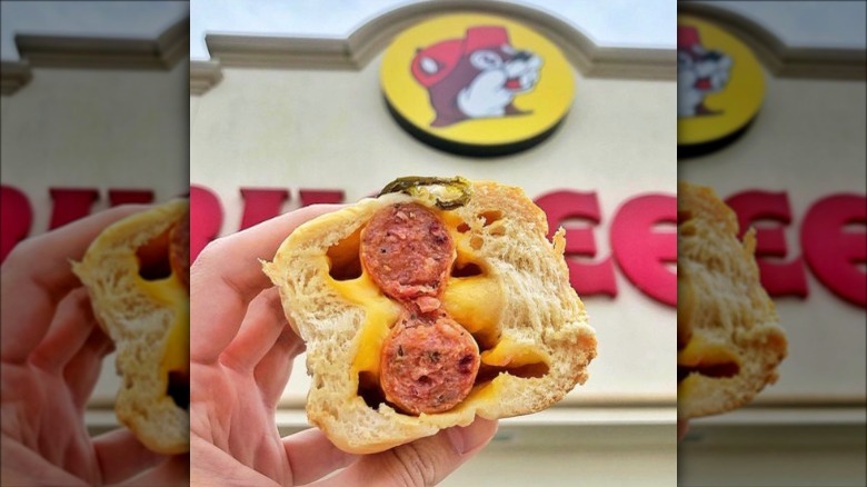 A hand holding up a Buc-ee's kolache