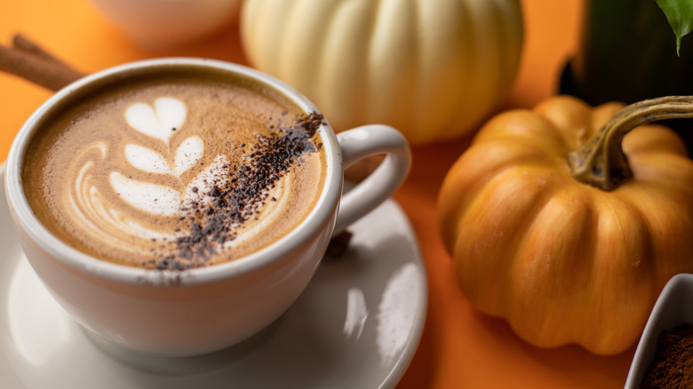 latte art next to pumpkins