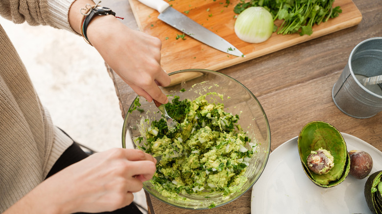 Woman making guacamole