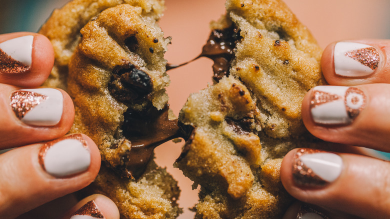 Pulling apart chocolate chip cookie