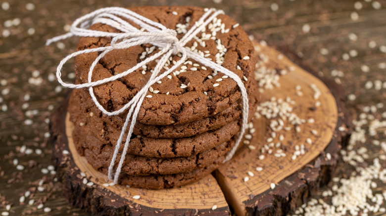 Walnut crisp cookies on a cross cutting of a tree tied with string