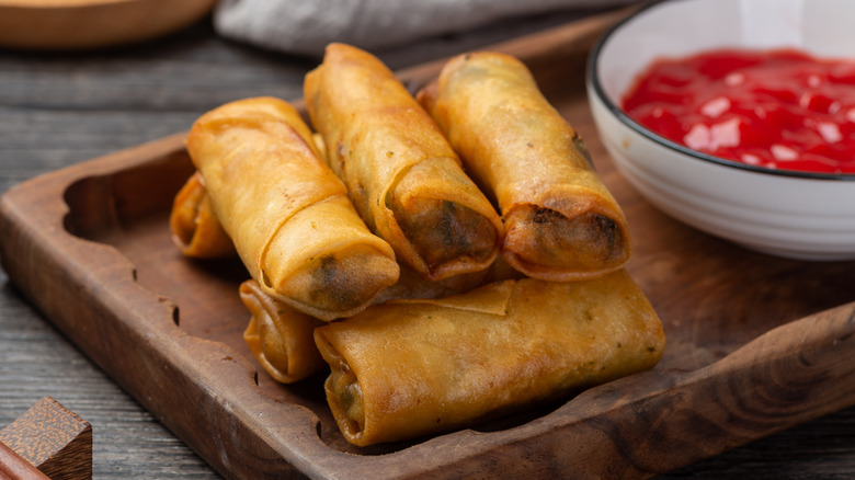 Pile of egg rolls and sauce