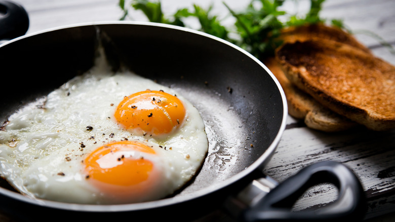 Two fried eggs in frying pan