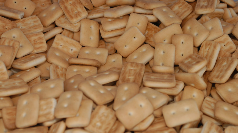A large pile of lightly toasted hardtack biscuits or crackers