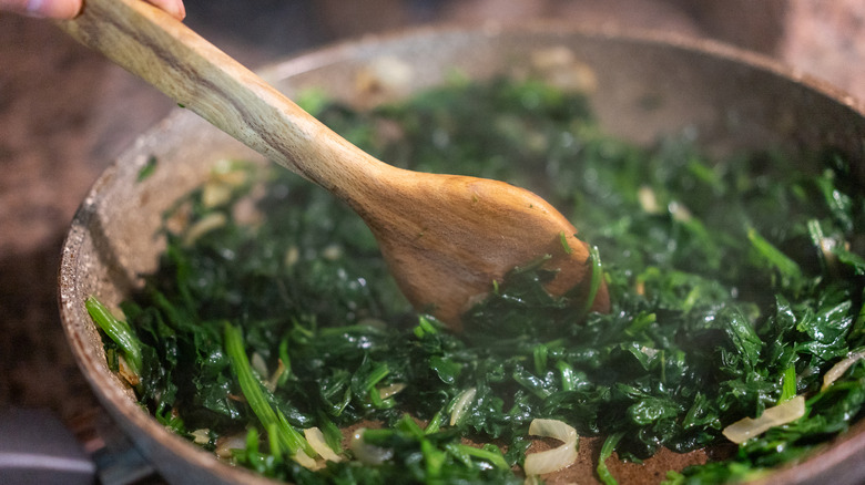 Wooden spoon used for sautéing spinach