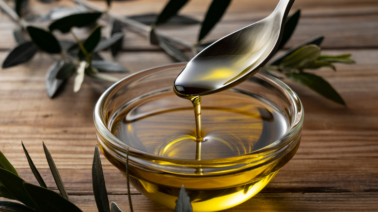 Spoon and bowl of olive oil