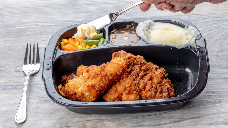 Fried Chicken TV dinner with cutlery on table