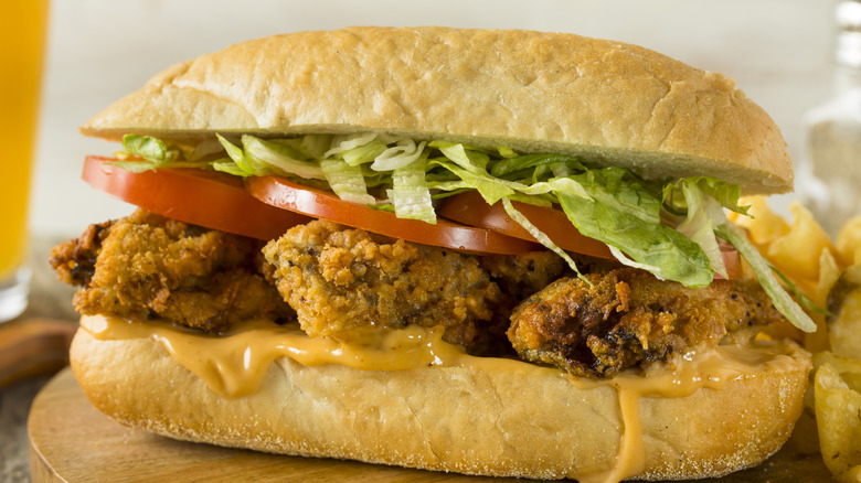 Fried oyster sandwich with tomatoes and lettuce