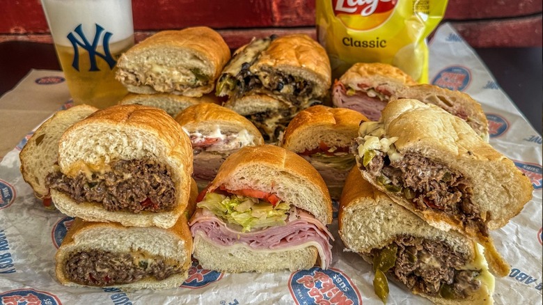 Pile of Jersey Mike's subs with beer and chips