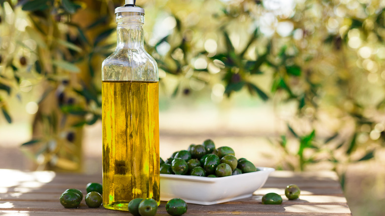 oil bottle with fresh olives 