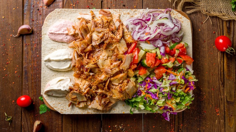 an unfolded chicken shawarma spread