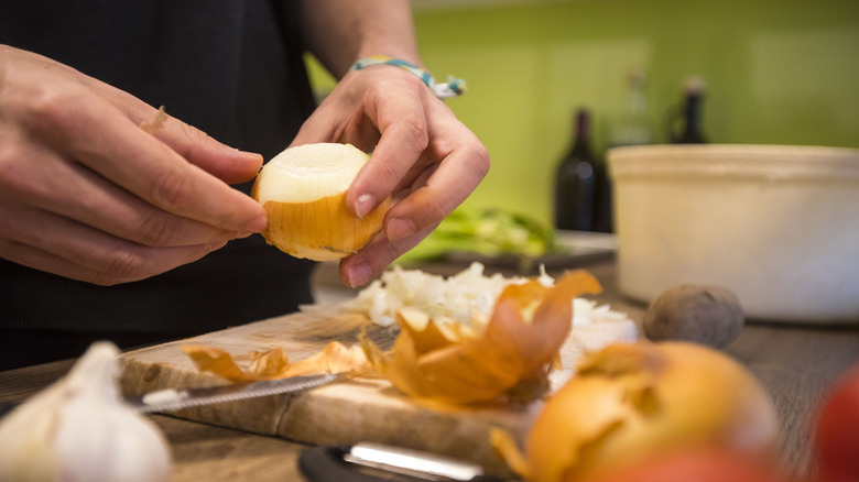 Cook peeling an onion