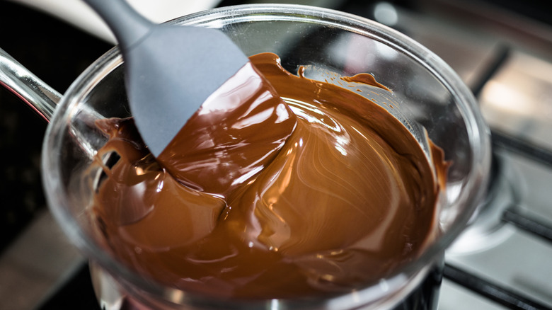Mixing melted chocolate in a double boiler on stovetop