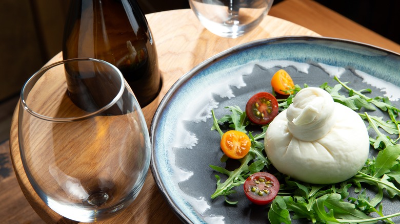 Burrata salad with wine glasses