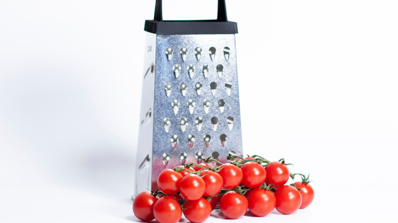 Box grater and tomatoes
