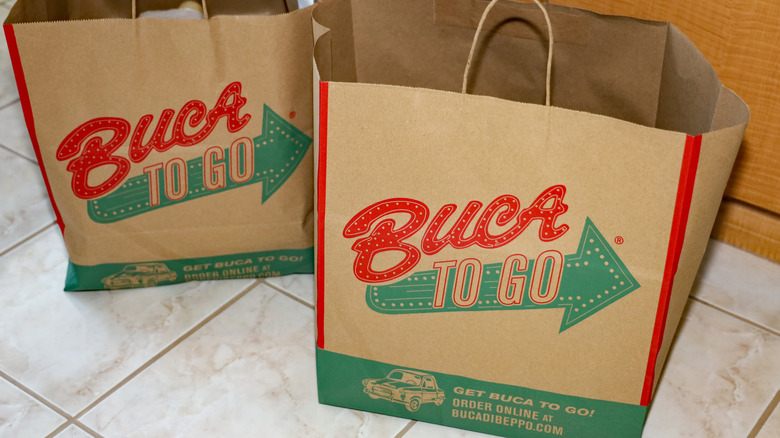buca di beppo to go bags on the floor, waiting for orders