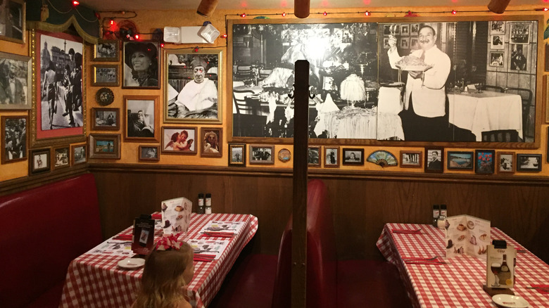 interior of buca di beppo with lots of decor, empty tables