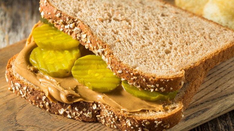 Closeup of a peanut butter and pickle sandwich