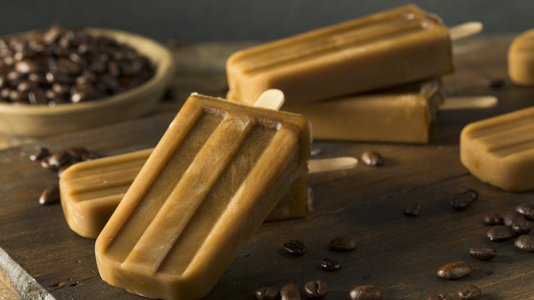Coffee popsicles on wooden table