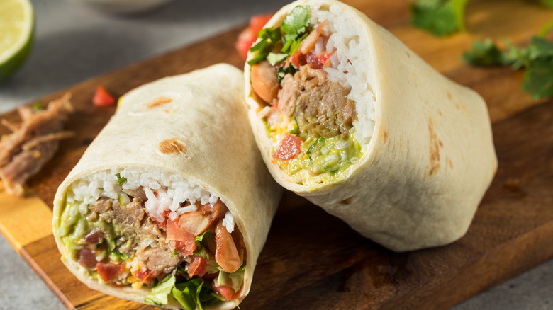 A burrito on a wooden board