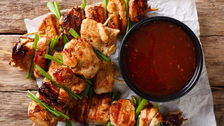 chicken kebabs with sauce on parchment paper