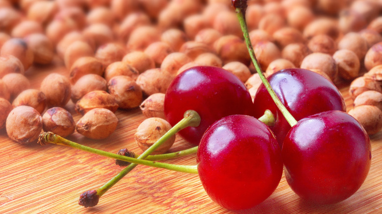 Cherries and cherry pits on a wooden table
