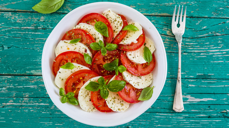 Caprese salad on blue table