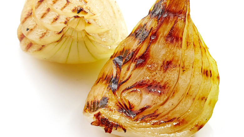 Grilled onion wedges on white background