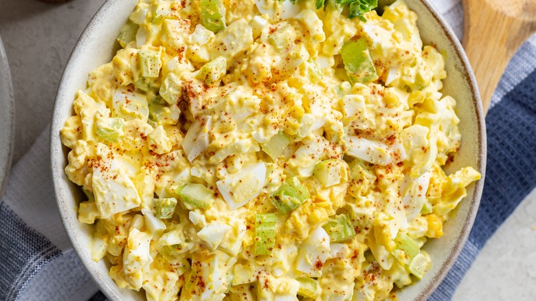 Top-down view of a bowl of egg salad with celery