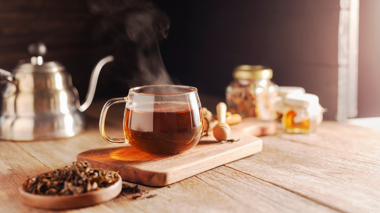 Cup of hot tea on a board