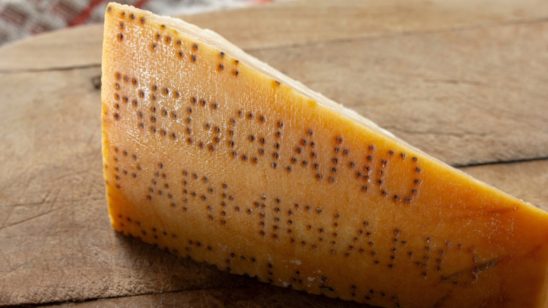 The rind of a wheel of Parmigiano Reggiano with the dot imprints showing its authenticity
