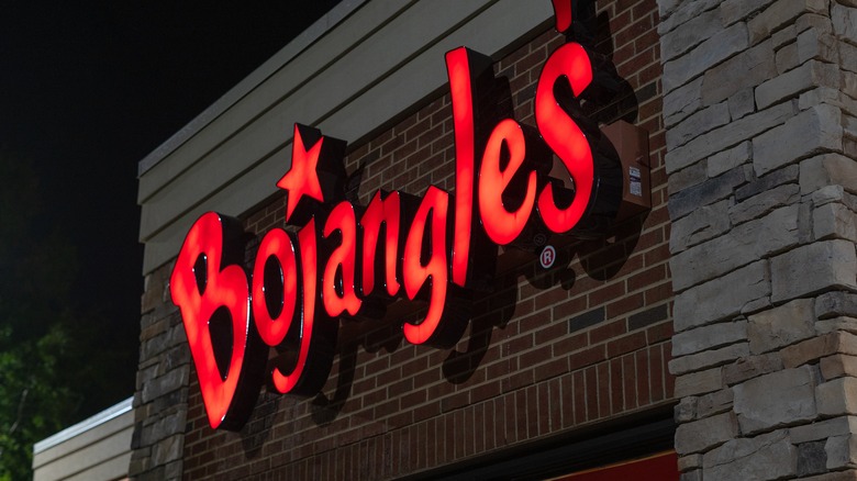 A Bojangles sign on the outside of a Bojangles location at night