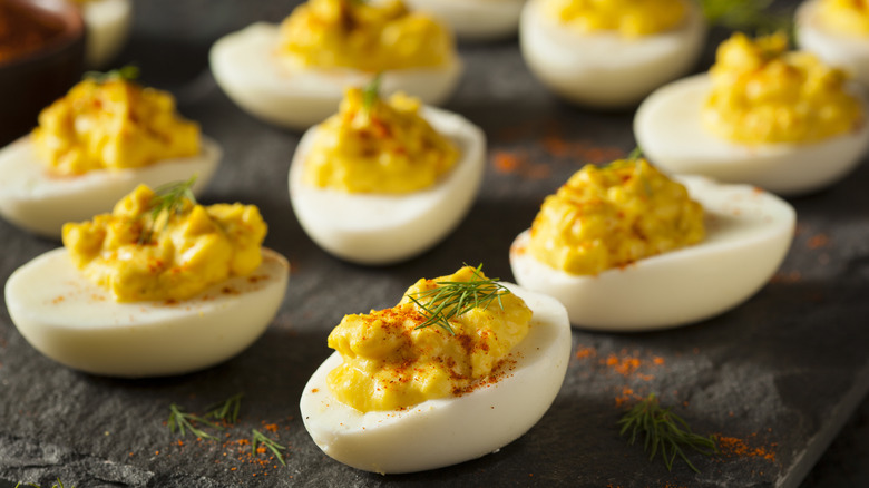 Deviled eggs with paprika and dill garnish
