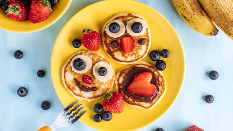 Pancakes with berry smiley faces