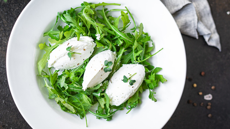 Cream cheese quenelles on salad