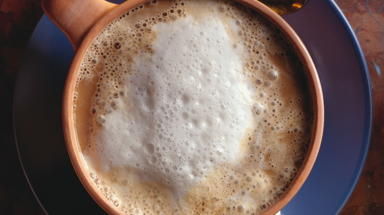 cup of frothy coffee from above