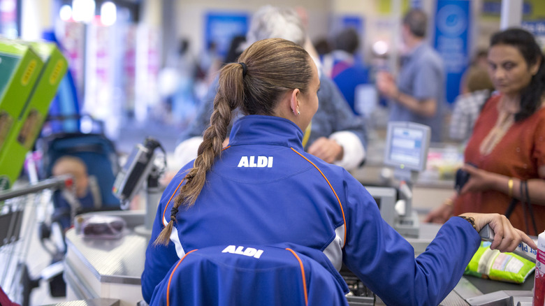 aldi cashier sitting at checkout
