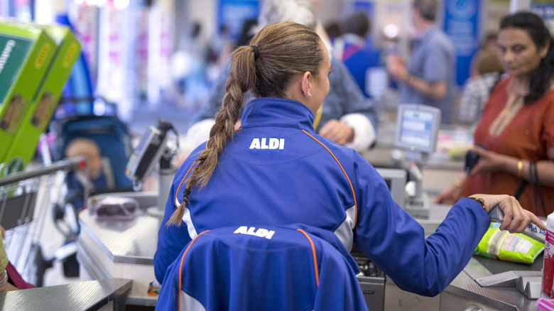 aldi cashier sitting at checkout