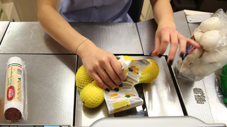 Aldi employee scanning groceries