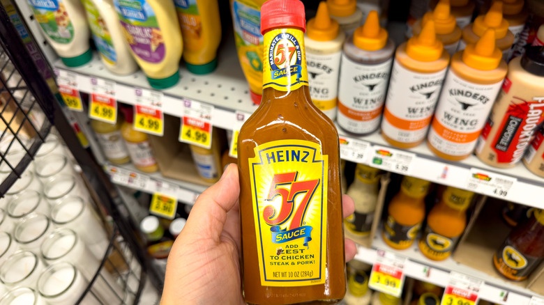 Heinz 57 sauce near a grocery store shelf of other sauces
