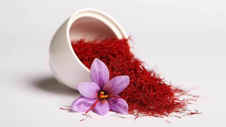 A spilled bowl of saffron with the flower