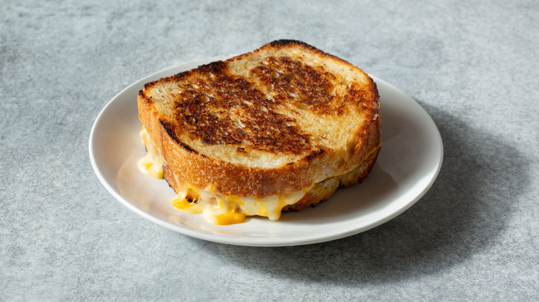 A cooked grilled cheese sandwich on sourdough bread.