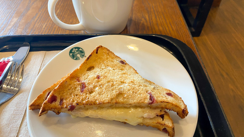 Starbucks Grilled Cheese sandwich half on branded plate