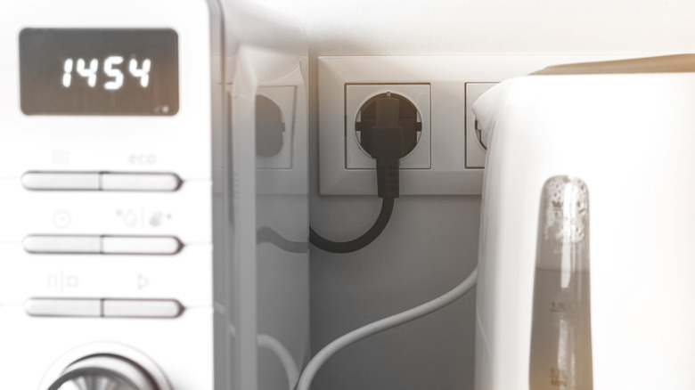 A microwave plugged into a wall