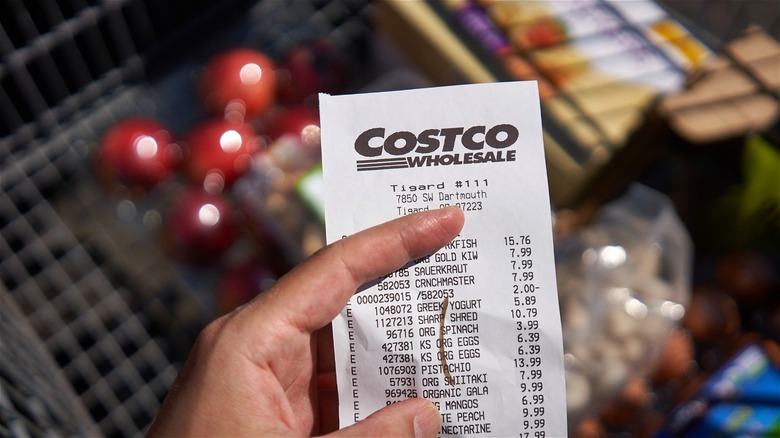 Marked Costco receipt in front of cart